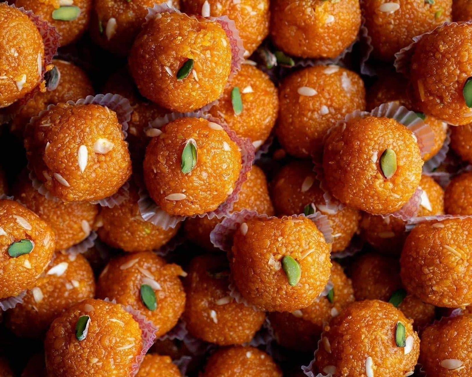 Delicious Indian laddoos topped with almonds and pistachios, perfect for festivals.